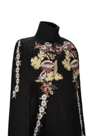 Black Wisteria cape jacket by Nadya Shah, featuring elegant draping and detailed floral-inspired design.