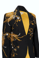 Nadya Shah INES in the Golden Age blazer, stylish tailored blazer in a rich golden hue, displayed on a hanger.
