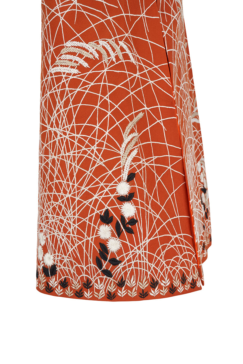 Nadya Shah clementine-colored cape jacket with flowing fabric and stylish design, perfect for layered winter or fall outfits.