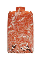 Nadya Shah Clementine Cape jacket in vibrant orange with flowing design, draped over a model showcasing stylish outerwear.