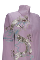 Nadya Shah Hydra Lilac Cape jacket shown on a model, featuring soft lilac fabric and stylish draped design.