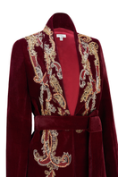 Brown smoking jacket by Nadya Shah featuring a classic design and luxurious fabric, displayed on a hanger.