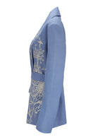 Nadya Shah NYLA powder blue belted jacket displayed on a hanger, showcasing its tailored fit and stylish belt detail.