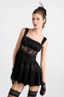 Black Naomi Jacqueline lace satin mini dress shown on a model, featuring elegant detailing and a fitted silhouette.