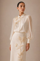Nihan Peker NAREEN vanilla co-ords set featuring a stylish top and matching pants on a model.