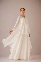 Nihan Peker Nazz vanilla gown with flowing fabric and elegant design, showcased on a model in a well-lit studio.