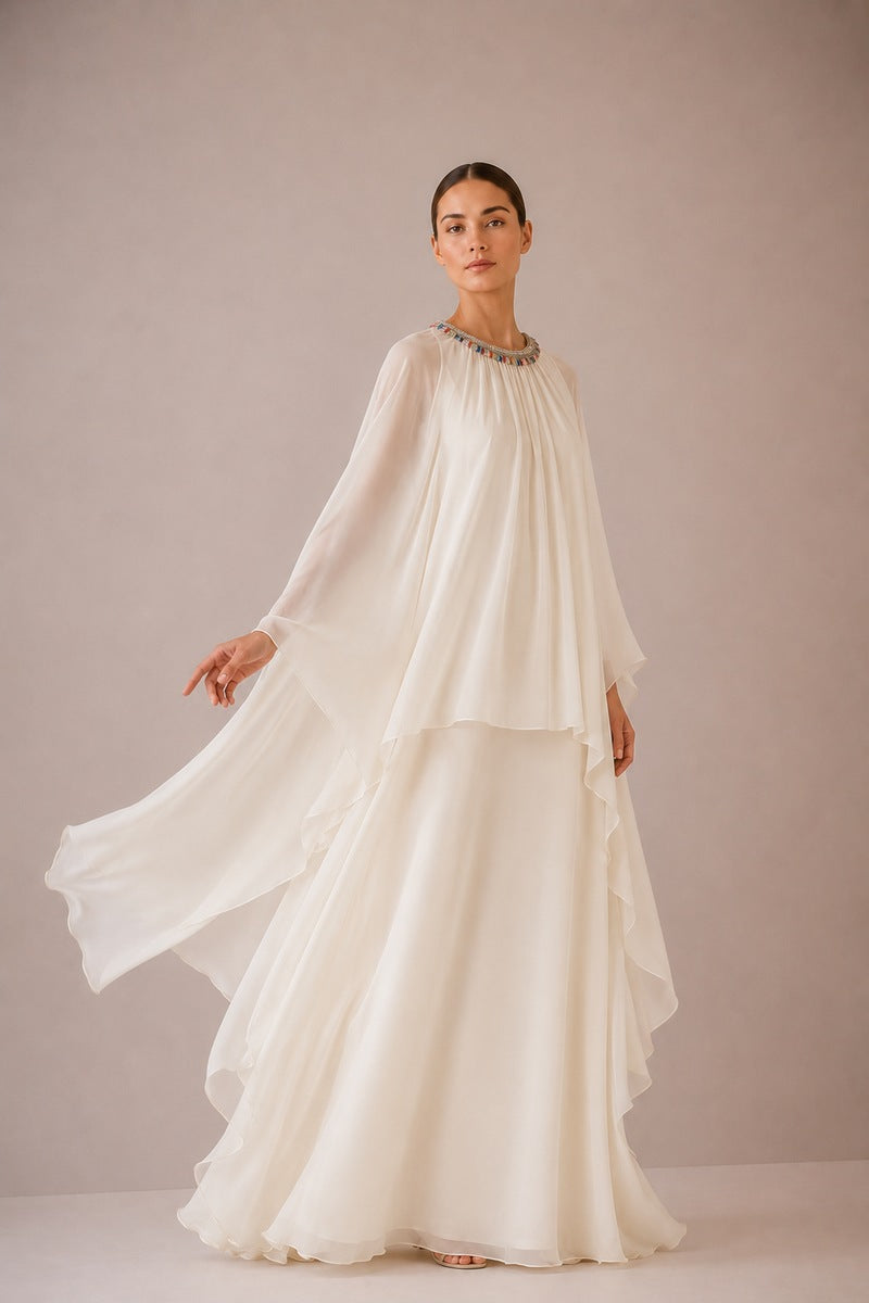 Nihan Peker Nazz vanilla gown with flowing fabric and elegant design, showcased on a model in a well-lit studio.