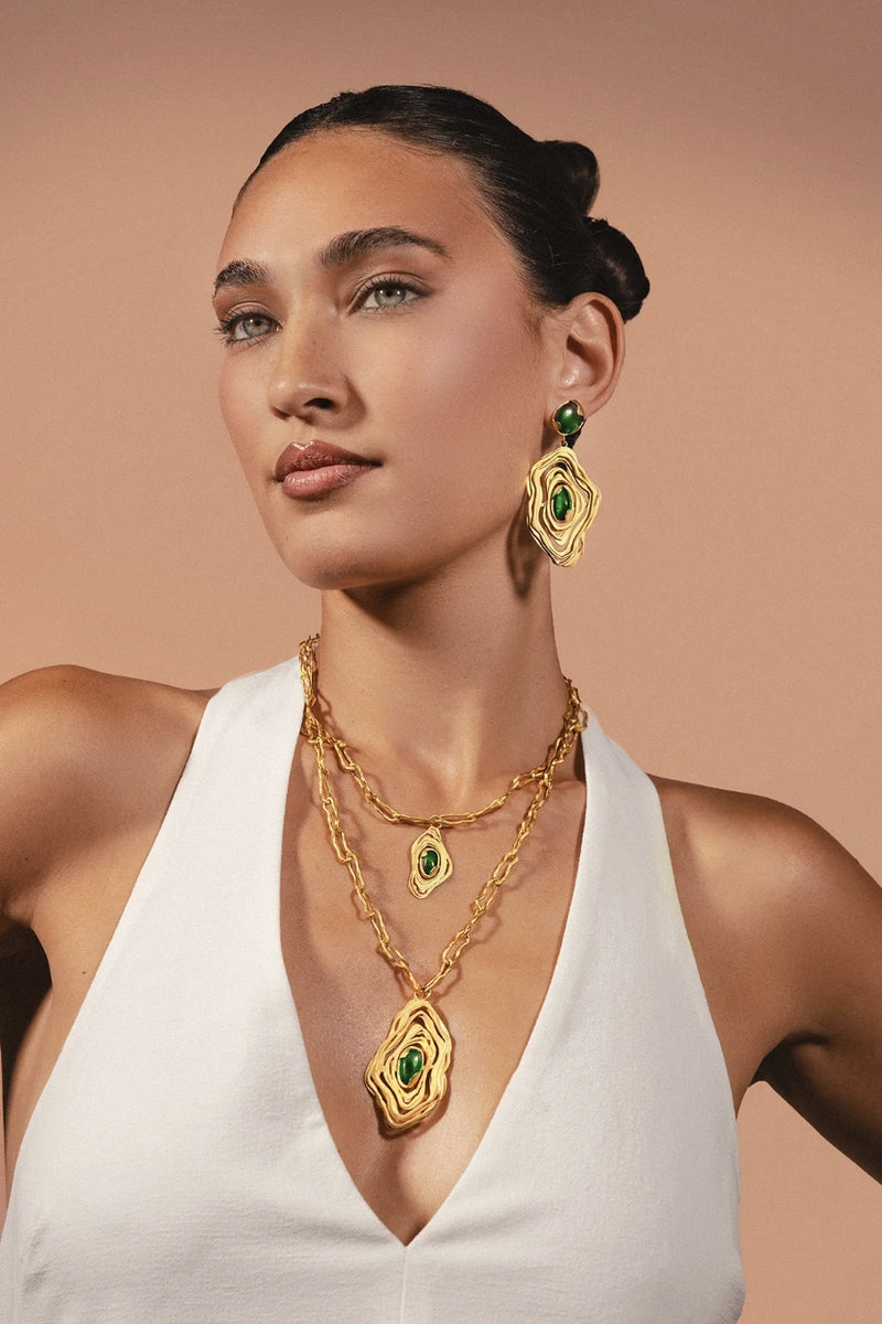 Gold and green nebula-inspired necklace by Jude Benhalim featuring a celestial design on a delicate chain.
