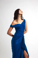 Deme by Gabriella Nellie electric blue draped maxi dress displayed on a hanger, showcasing its flowy fabric and elegant design.