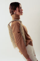 White Neus crochet shoulder bag by Millanne Tale, featuring a stylish and spacious design with a woven texture.