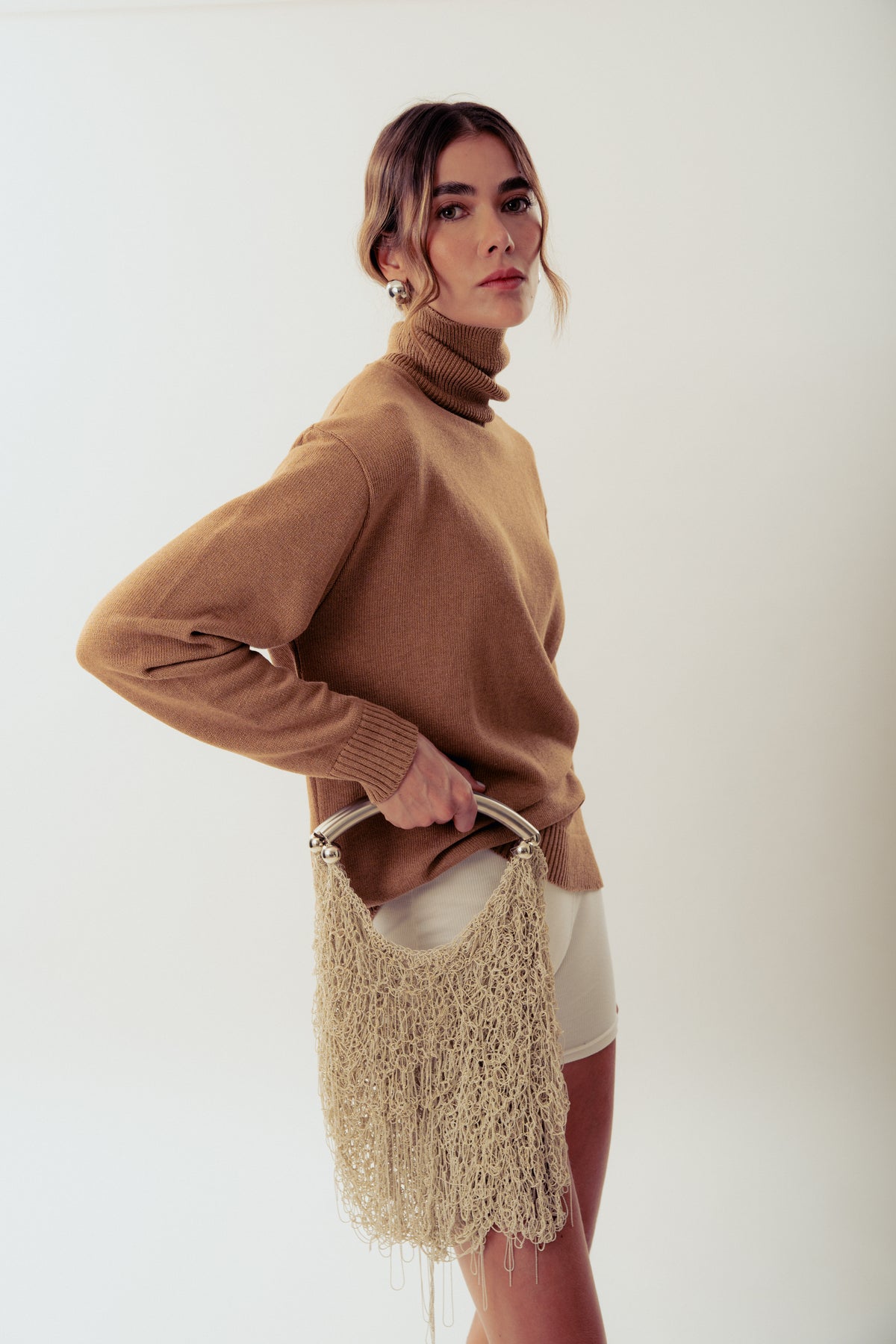 White Neus crochet shoulder bag by Millanne Tale, featuring a stylish and textured design perfect for everyday use.
