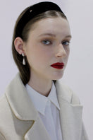 Silver toned earrings by Aethera with a sleek, modern design, displayed on a white background.