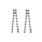 A pair of sleek MAJA earrings by Aethera featuring modern geometric design in shiny metal.