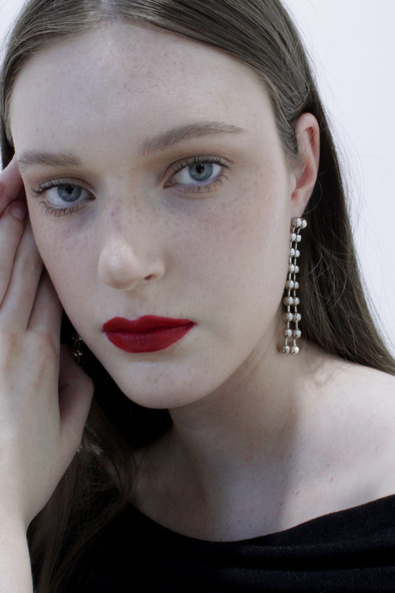 Aethera Maja earrings featuring elegant, gold-toned earrings with intricate detailing and a modern design.