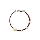 Aethera Kristen Garnet Pearl Bracelet featuring vibrant garnet beads and elegant pearl accents on a delicate chain.