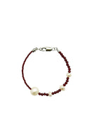 Aethera Kristen Garnet Pearl Bracelet featuring vibrant garnet beads and elegant pearl accents on a delicate chain.