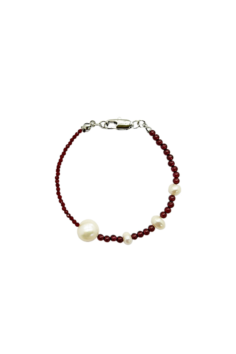 Aethera Kristen Garnet Pearl Bracelet featuring vibrant garnet beads and elegant pearl accents on a delicate chain.