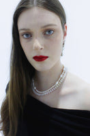 Aethera Cruisie Pearl Necklace featuring elegant white pearls and delicate chain, perfect for sophisticated jewelry styling.