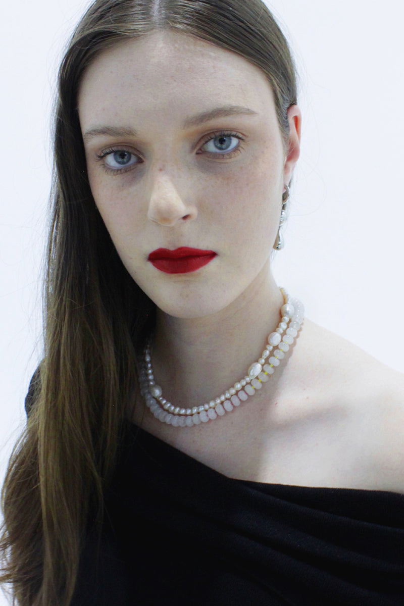 Aethera Cruisie Pearl Necklace featuring elegant white pearls and delicate chain, perfect for sophisticated jewelry styling.