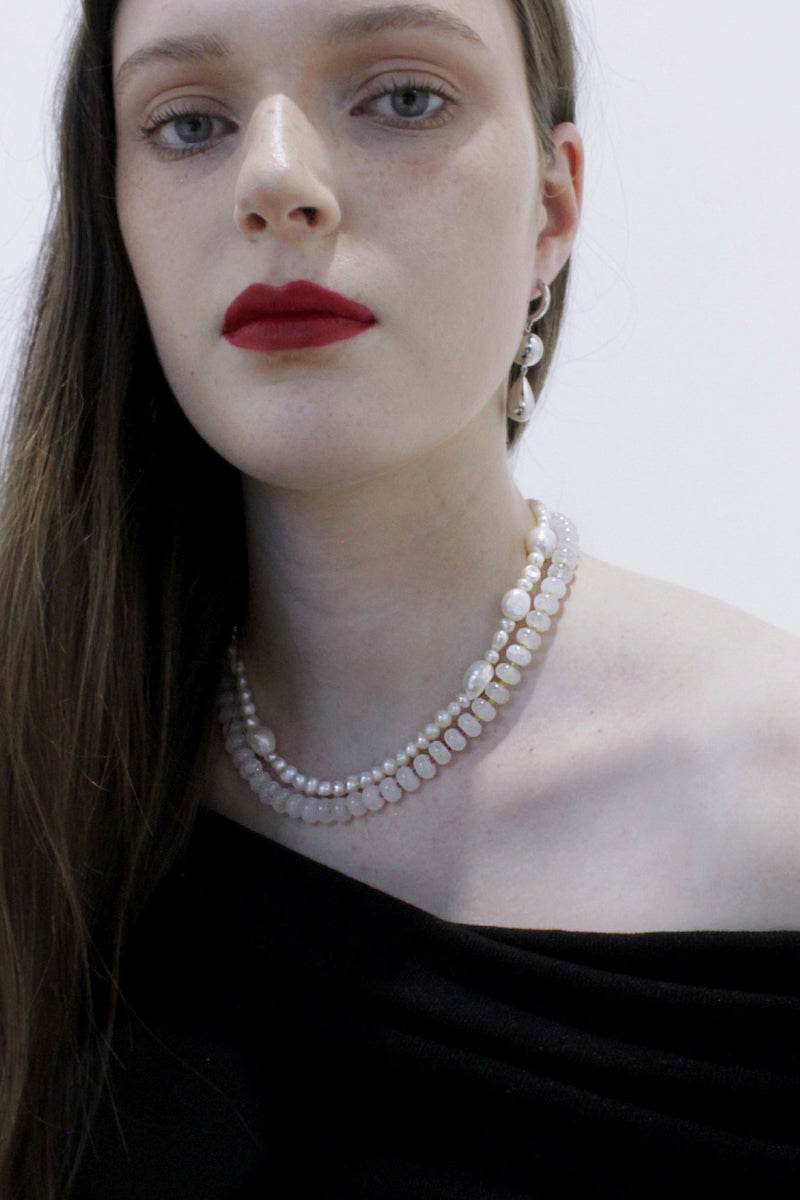 Aethera Cruisie Pearl Necklace featuring elegant white pearls on a delicate chain, perfect for sophisticated style.