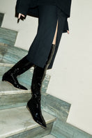A pair of AERA Nicoletta black patent-effect boots with sleek shiny finish and stylish ankle-high design.