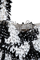Close-up of SAC DE SOUL Nina white and black top handle bag showing sleek design and high-quality leather details.
