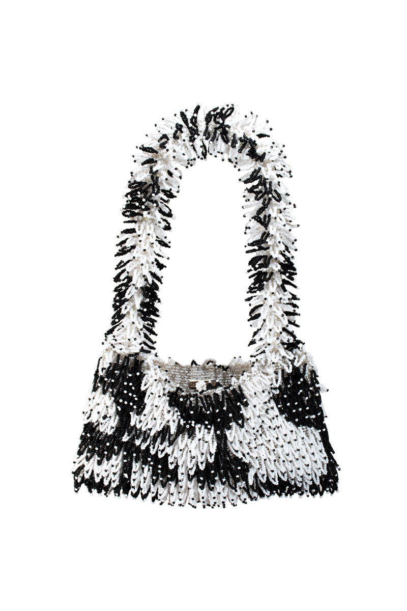SAC DE SOUL Nina white and black top handle bag with sleek design and structured shape, front view showing elegant style.