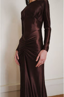 Close-up of YASSMIN SALEH Nocturne Dress in brown, showcasing the elegant gown's fabric and detailed design.