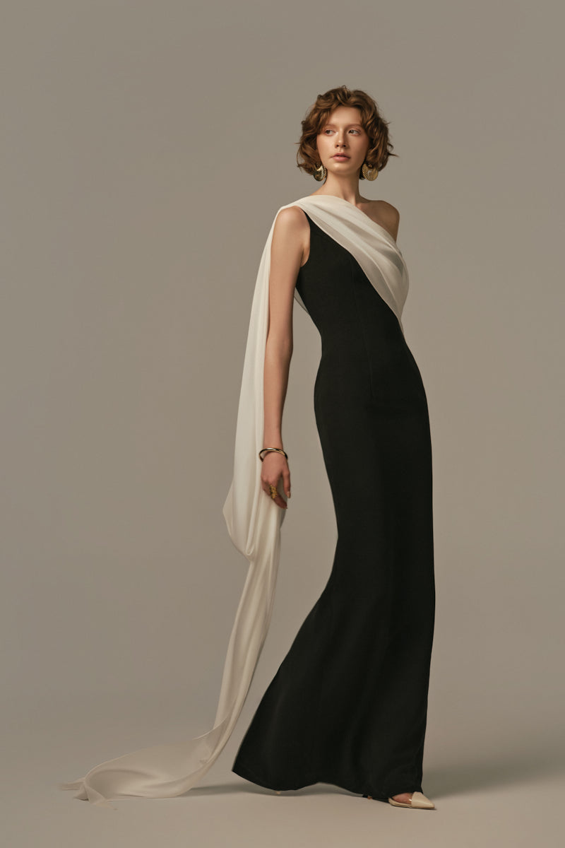 Poem Nocturne gown in white and black, featuring elegant fabric and stylish design, worn by a model in the image.