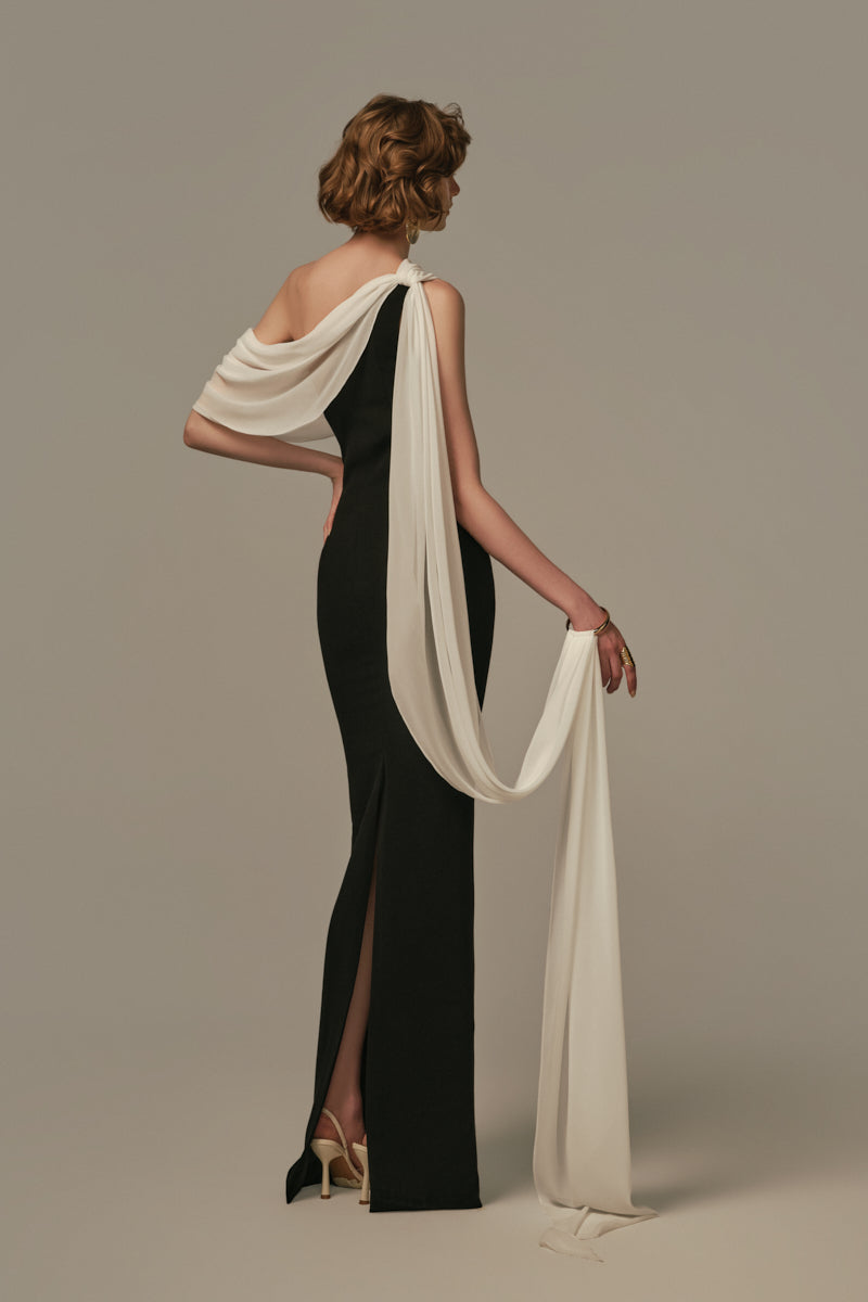 Poem Nocturne gown in white and black, featuring elegant fabric and detailed design, modeled on a person with a stylish look.