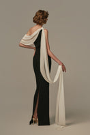 White and black NOCTURNE gown by POEM, elegant long gown with flowing fabric, showcased on a model.