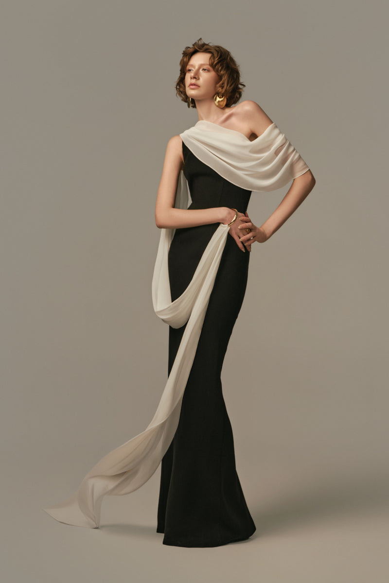 Poem Nocturne gown in white and black, featuring elegant fabric and stylish design, modeled on a person in this product image.