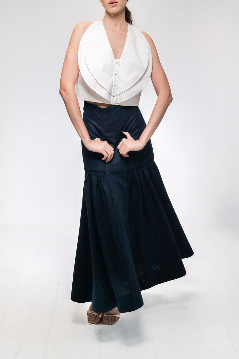 Navy blue Noelle maxi skirt by ANA + MARIA, flowing fabric with a stylish, elegant silhouette, displayed on a white background.