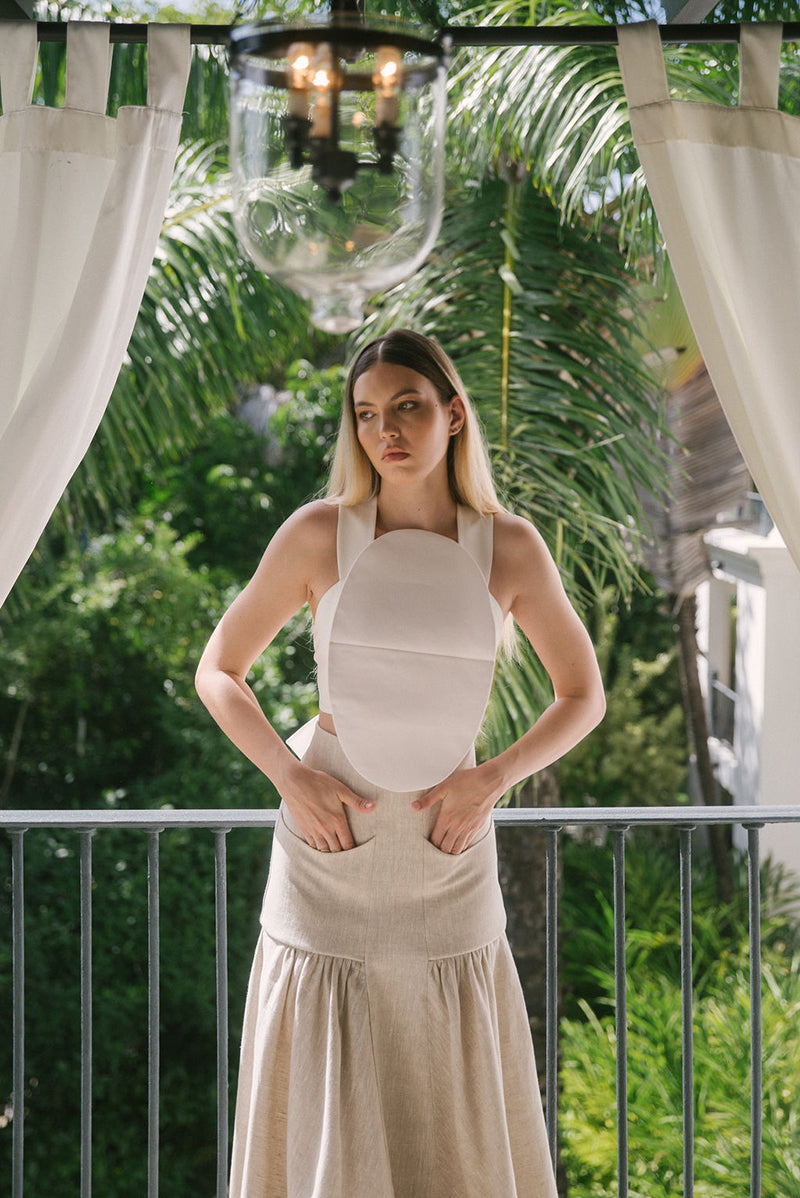 Ana + Maria Noelle Maxi Skirt in sand, flowing fabric with a high waist, styled in a fashion campaign photo.