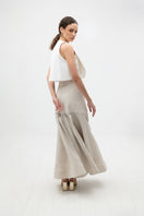 Cream-colored maxi skirt by ANA + MARIA, Noelle Skirt in Sand, flowing fabric with a relaxed fit and elegant design.