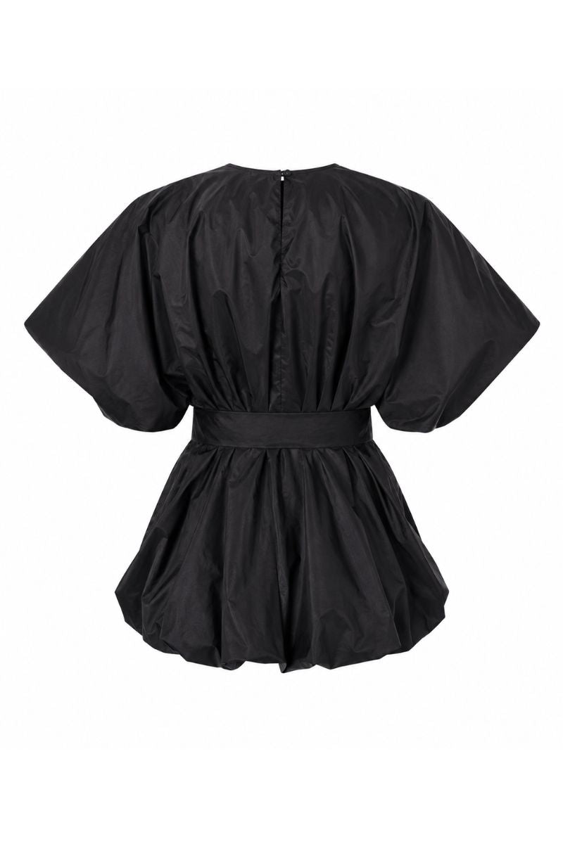 Black Nonora blouse by ANA + MARIA displayed on a ghost mannequin, showcasing the stylish, fitted top with long sleeves.