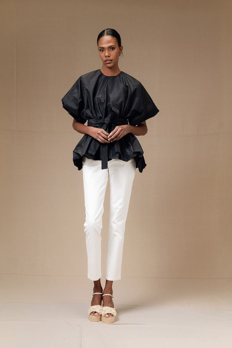 Black Nonora blouse by ANA + MARIA, featuring long sleeves and a relaxed fit, shown on a plain background.