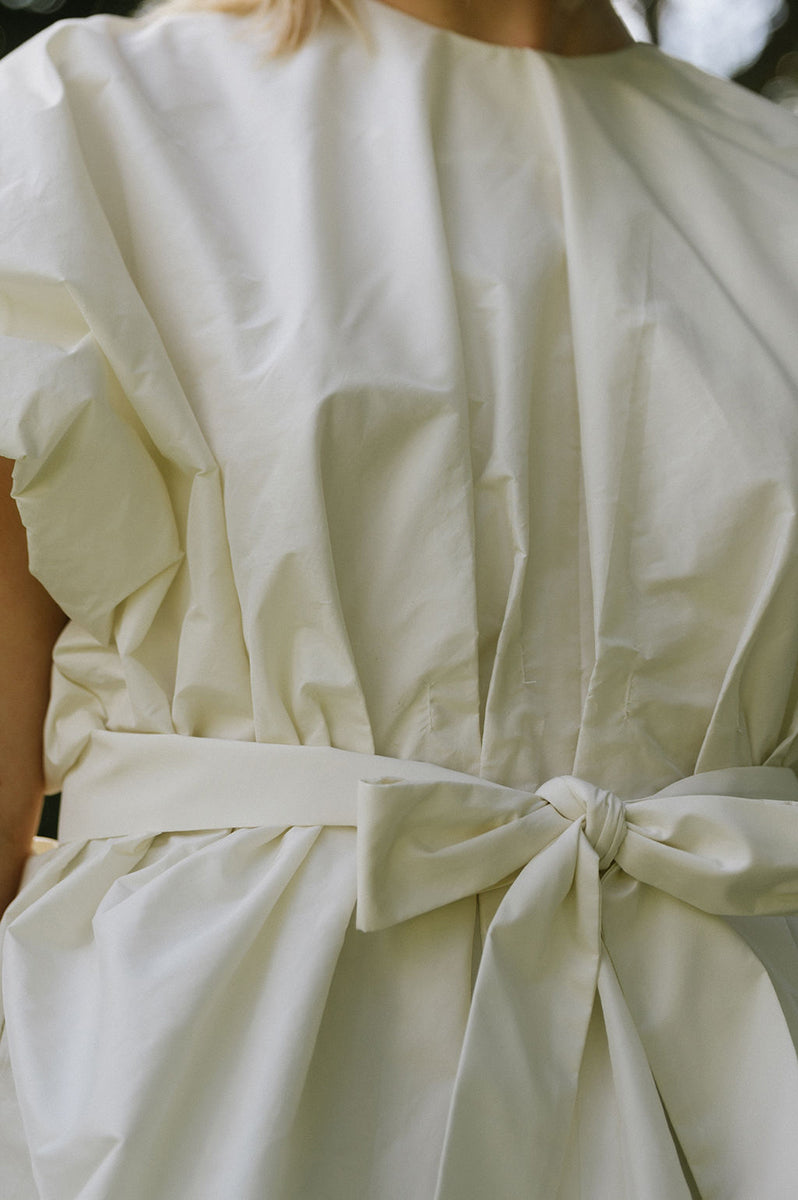 Cream-colored Nonora blouse by ANA + MARIA, showcasing a stylish and elegant tops design with soft fabric and tailored fit.