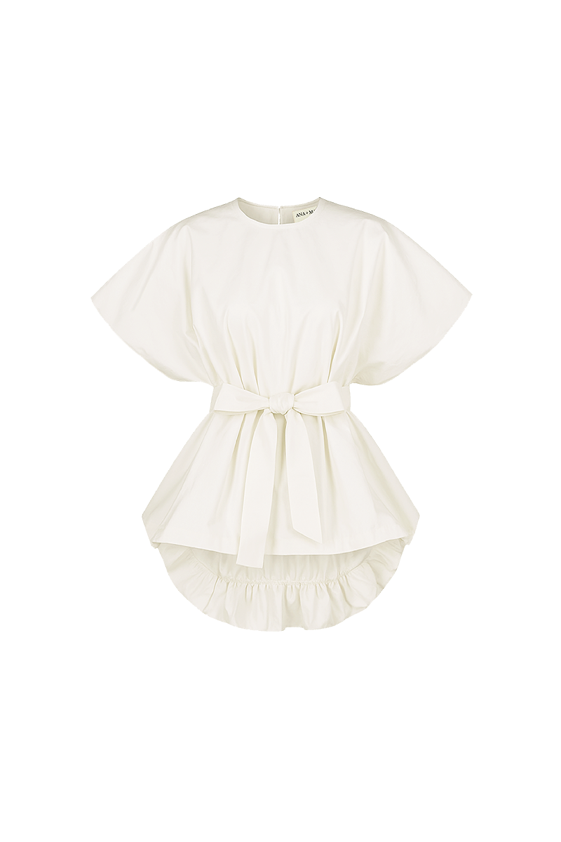 Cream-colored Nonora blouse by ANA + MARIA, shown in a ghostly photo, featuring soft fabric and stylish design details.