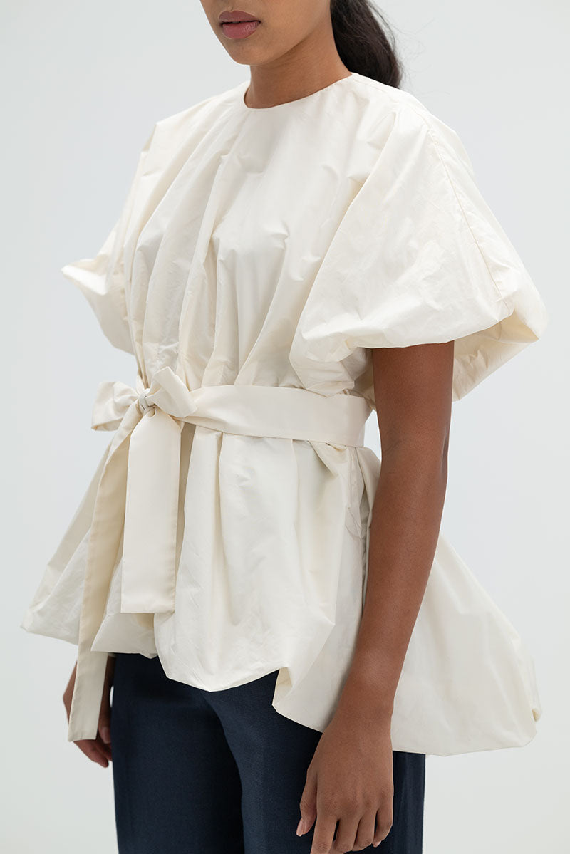 Ana + Maria Nonora blouse in ivory, stylish women’s top with a relaxed fit and elegant design, shown in a high-resolution image.