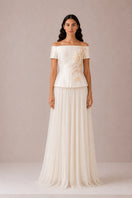Nihan Peker Nora top in vanilla color, sleeveless blouse with a relaxed fit, displayed on a hanger.