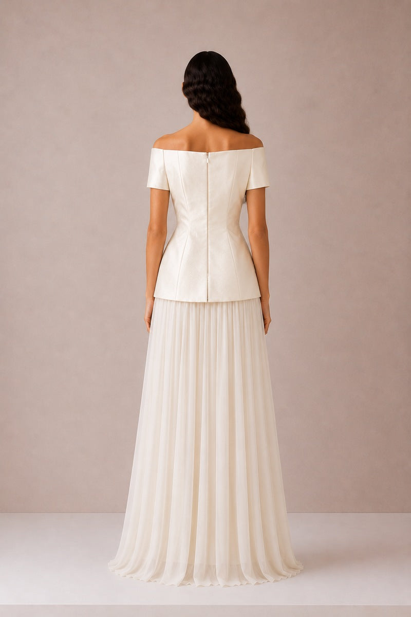 Nihan Peker Nora Top in vanilla, casual sleeveless blouse with a relaxed fit and V-neck, displayed on a hanger.