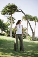 Elegant ivory Nova blouse from ANA + MARIA with a soft, flowing fabric and detailed neckline, styled as a top in a fashion campaign photo.