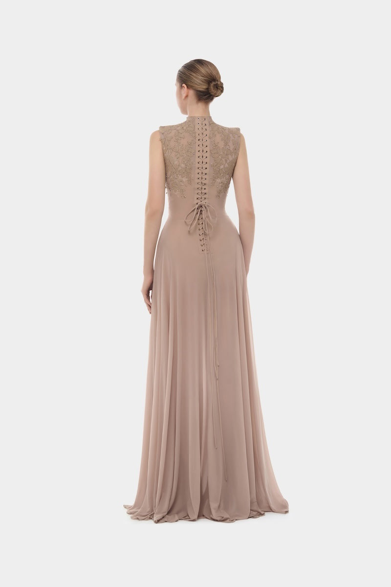 Nude sleeveless jacquard maxi dress by Montsand, flowing fabric with intricate woven pattern, full-length design for elegant occasions.