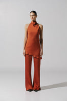 Baobab Numa pants in terracotta, stylish and comfortable women's pants with a relaxed fit, shown in a natural pose.