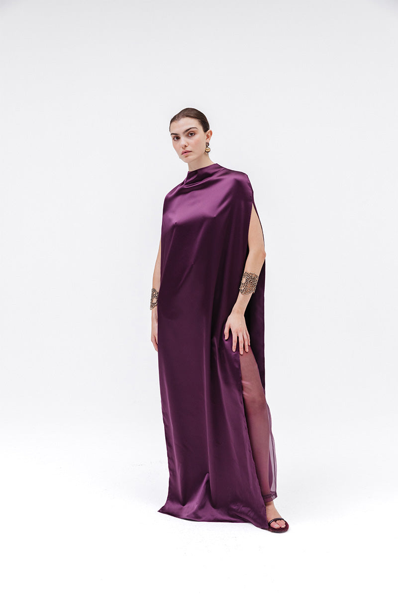 Studio NK Obscura cape in aubergine, a stylish women’s top with a flowing design and rich purple color.