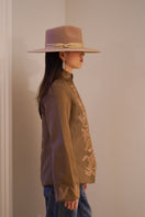 Nadya Shah Odessa jacket hanging on a hanger, featuring a stylish, lightweight outerwear design in neutral tones.