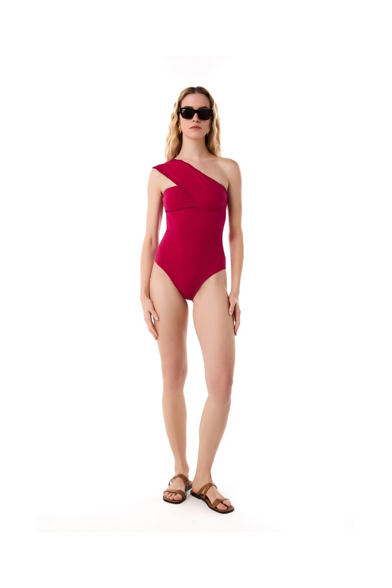 KÍOHNE Olivia swimsuit in vibrant wild magenta featuring a stylish, fitted design and smooth fabric visible in the image.