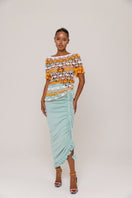 Handmade crochet top by Andreeva featuring vibrant orange and blue Bird of Paradise design, displayed on a neutral background.