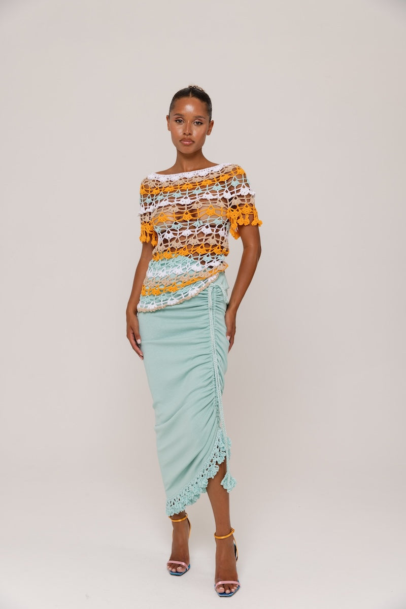 Handmade crochet top by Andreeva featuring vibrant orange and blue Bird of Paradise design, displayed on a neutral background.